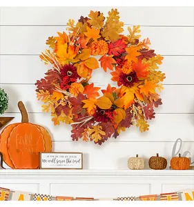 Vibrant autumn wreath with maple leaves and sunflowers on a white fireplace mantel