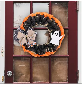 Halloween ghost wreath with orange and black burlap on a red wooden door detail