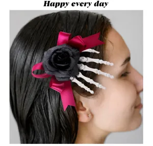 Detail view of Halloween skeleton hand hair clip with black rose and magenta bow on hair