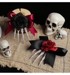 Macro view of Halloween skeleton hand hair clips featuring gothic rose and ribbon bow details