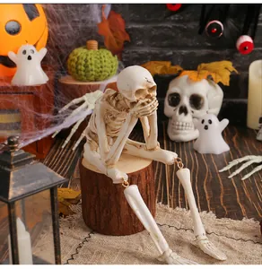 Detailed close-up of a resin Halloween skeleton ornament in a spooky festive setting.