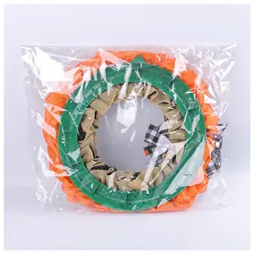 Halloween festive wreath with burlap bow and orange mesh inside clear plastic packaging.