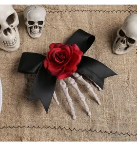 Detailed view of Halloween hair clip featuring a skeleton hand, black bow and red rose