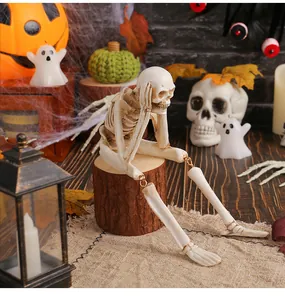 Sitting resin skeleton figurine in thinking pose for Halloween desktop decoration.