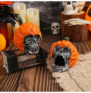 Detailed view of Halloween resin skulls wearing decorative carved orange pumpkin hats