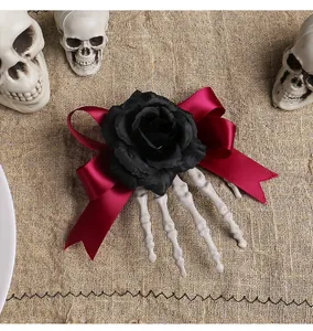Detailed view of Halloween skeleton hand hair clip with black rose and burgundy bow