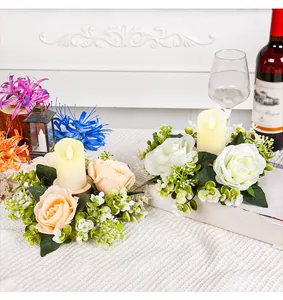 Elegant floral candle wreath centerpiece with artificial roses and warm LED candles.