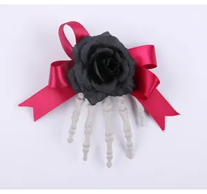 Detailed view of a Halloween hair clip featuring a black rose, pink bow and skeleton hand