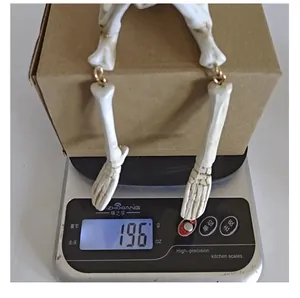 Close-up showing the 196g weight measurement of this resin skeleton ornament.