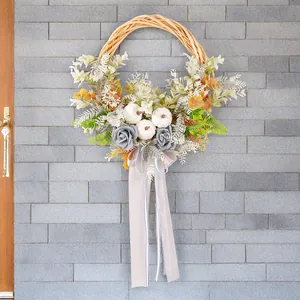 Couronne d'automne avec citrouilles blanches et roses grises pour la fête des récoltes.