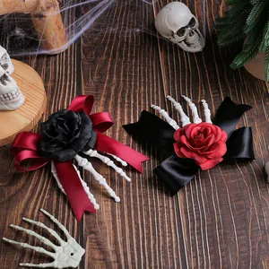 Halloween skeleton hand hair clips with red and black roses and bows on wood background