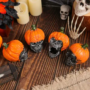 Set of four Halloween resin skull ornaments with pumpkin hats for spooky holiday table decor