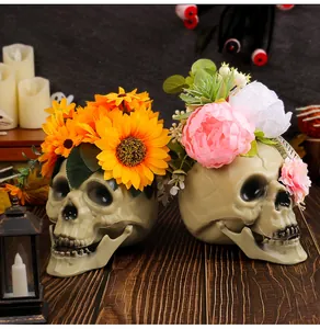Detail of Halloween skull ornaments with vibrant artificial sunflowers and peonies.