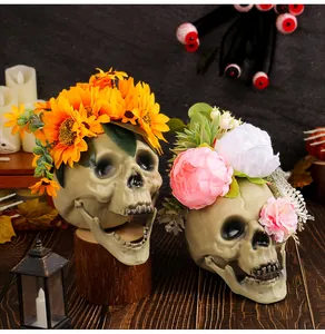 Detailed view of Halloween skull head props with sunflower and peony flower crowns.
