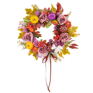 Harvest autumn wreath with roses pumpkins and maple leaves on a white background