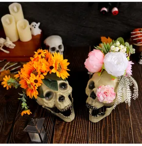 Detailed view of Halloween skulls decorated with artificial sunflowers and peonies.
