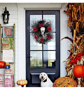 Macro view of Halloween wreath with skeleton and red roses hanging on a dark door