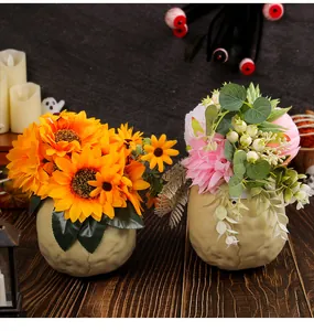 Halloween skull flower arrangement with vibrant sunflowers and pink dahlias for decor.