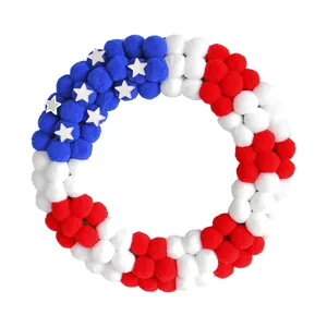 Patriotic July 4th wreath with red white and blue pom-poms for front door decoration
