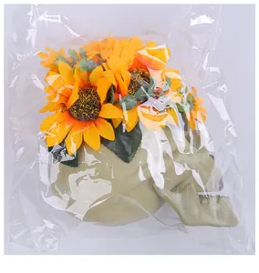 Detailed view of Halloween skull decoration with sunflowers in plastic packaging