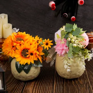 Halloween skull vase with artificial sunflowers and flowers for haunted house decor.