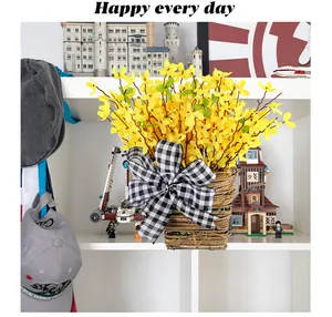 Decoratieve gevlochten bloemenmand met gele bloemen en een zwart geruite strik.