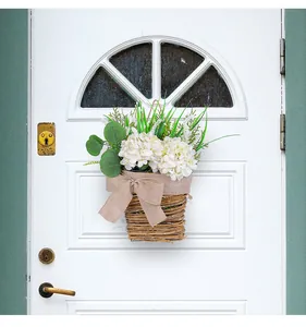 Detail of a decorative white hydrangea flower basket door hanger on a white wooden door