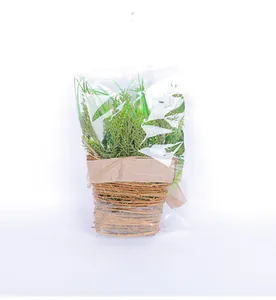 Artificial greenery in woven basket with burlap bow, detail of product in clear packaging