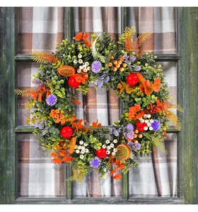Vibrant eucalyptus wreath with orange slices and red berries for front door decor