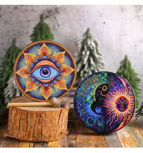 Artistic handmade Shamanic drums featuring vibrant eye and celestial sun and moon designs
