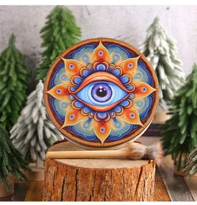 Intricate eye mandala pattern on a handcrafted Siberian shamanic drum with mallet
