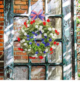 Detailed view of patriotic Independence Day wreath with red white blue roses and bow