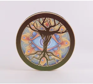 Artistic shamanic drum featuring tree of life and eye design on white background