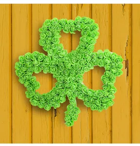Close-up detail showing the intricate green foam roses on a shamrock wreath for St. Patrick's Day
