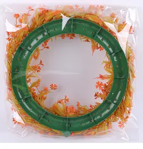Rear view of artificial spring wreath with green plastic frame in clear packaging