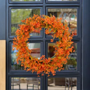 Vibrant orange artificial spring wreath for outdoor front door holiday decoration
