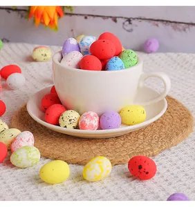 Close-up of colorful 2x2.5cm mini spotted Easter eggs in a white teacup