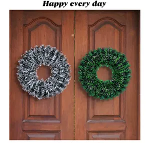 Detail view of black and green 42cm Christmas tinsel wreaths hanging on a wooden door.