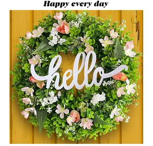 Detailed view of spring eucalyptus wreath with white hello sign for home door decoration