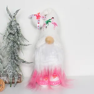 Detailed view of a white Christmas gnome with pink flamingo embroidery and ombré beard