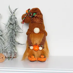 Close-up of autumn plush gnome featuring Give Thanks embroidery and a pumpkin accessory