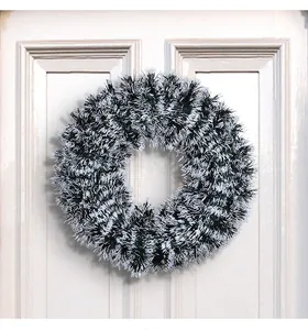 Detail shot of a black and white 42cm tinsel Christmas wreath on a white door