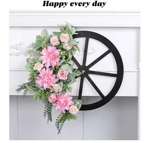 Detail of pink floral wagon wheel wreath for outdoor garden door decor hanging.