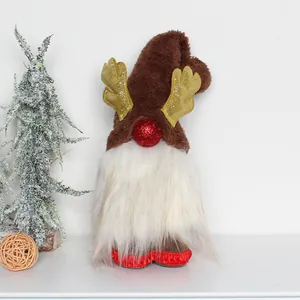 Close-up of a festive Christmas gnome with golden antlers and a plush white beard