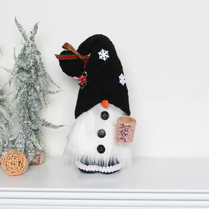 Detail of Christmas gnome plush doll with black hat and white beard on a white shelf