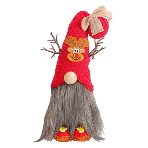 Detailed view of a Christmas gnome doll featuring a red plush hat and reindeer antlers