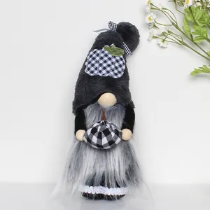 Handmade Halloween gnome plush holding black and white plaid pumpkin on white background