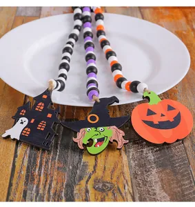 Detail of Halloween wooden bead garlands with witch, pumpkin, and castle charms