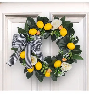 Lemon wreath with black and white striped bow, artificial leaves and roses for door decor