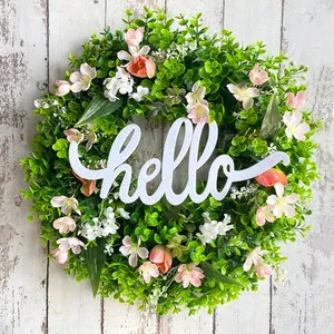 Decorative spring eucalyptus flower wreath with white hello sign for front door decor